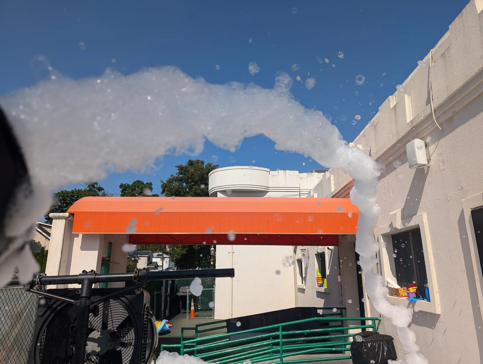 Foam spraying across an outdoor event space